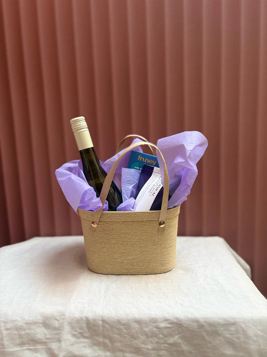 Moody Blues woven gift basket with wine wrapped in lilac tissue