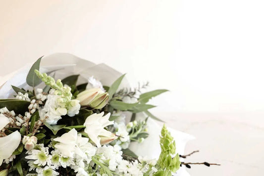 Close-up of a white and green bouquet with lilies and stock