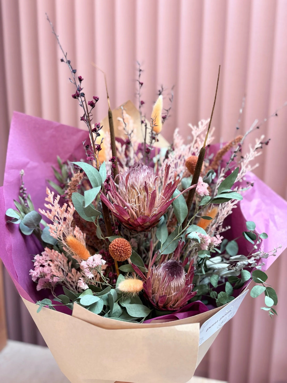Rainbow dried flower arrangement with protea and pampas