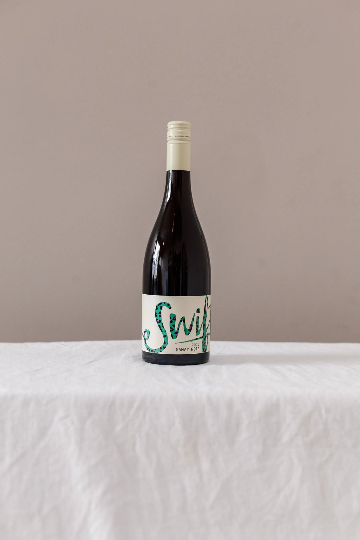 Swift Wines Gamay Noir bottle on a linen-draped table