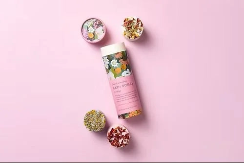 Botanical Skincare floral bath bomb gift tube with bath bombs on pink