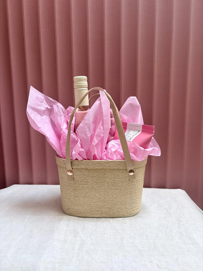 Woven Pinky gift basket wrapped with pink tissue
