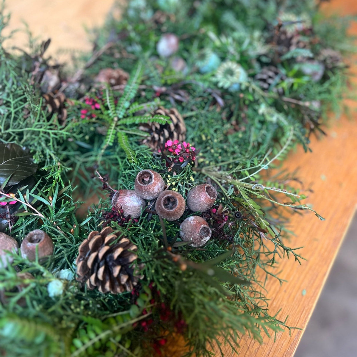 Close-up of a fresh Christmas wreath with pine, pinecones and gum nuts