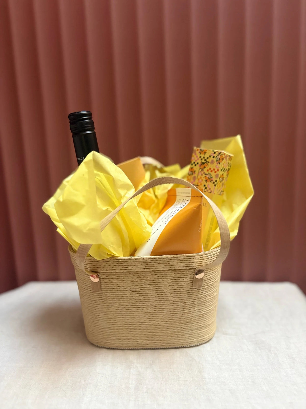 Sunshine woven gift basket wrapped in yellow tissue