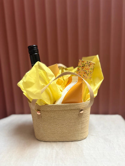 Sunshine woven gift basket wrapped in yellow tissue