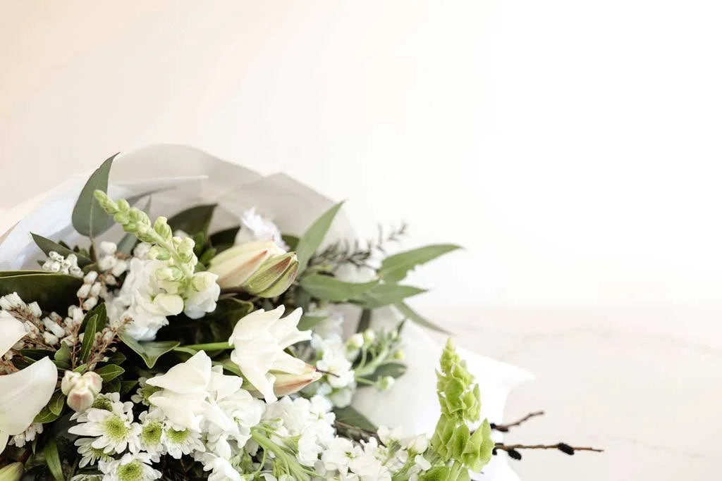 Close-up of a white and green bouquet with lilies and stock