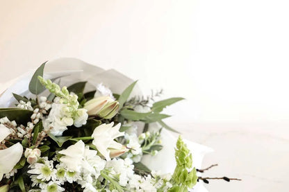 Close-up of a white and green bouquet with lilies and stock