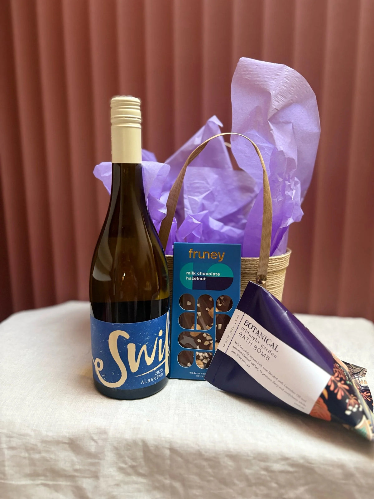 Moody Blues gift basket with Swift wine, chocolate and lilac tissue