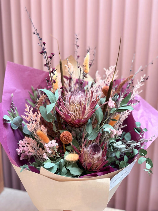 Rainbow dried flower arrangement with protea and pampas