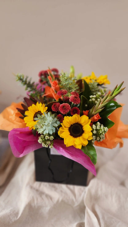 Bright seasonal bouquet with sunflowers and orange roses