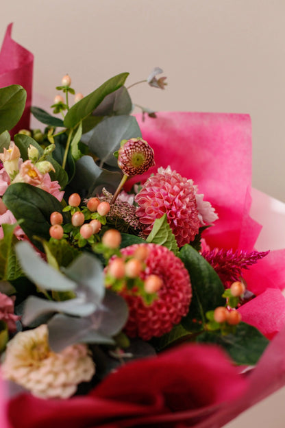 Close-up of red protea, roses and eucalyptus in a lovers bouquet