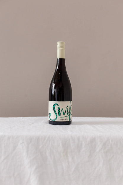 Swift Wines Gamay Noir bottle on a linen-draped table