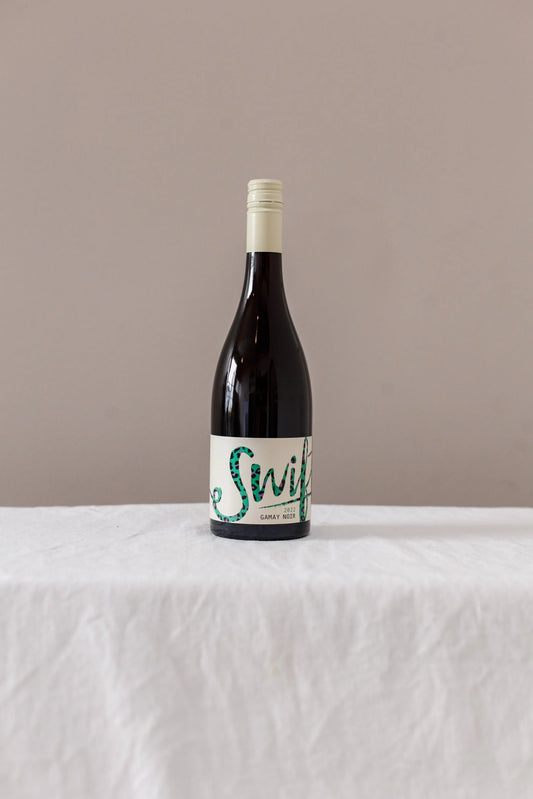 Swift Wines Gamay Noir bottle on a linen-draped table