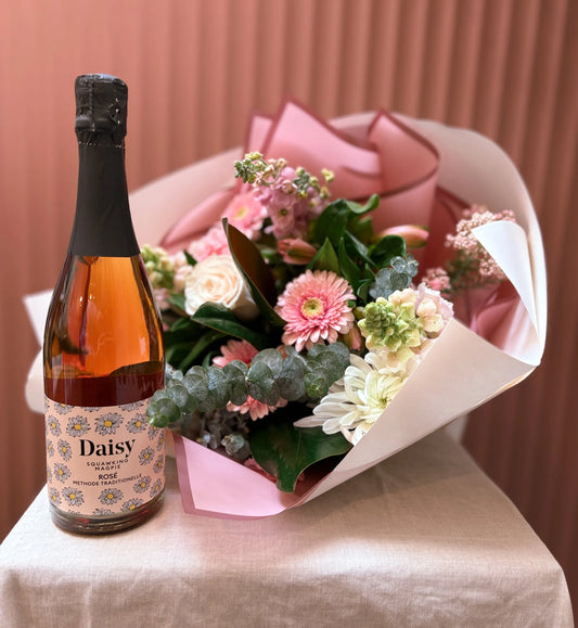 Pink flower bouquet paired with Squawking Magpie sparkling wine