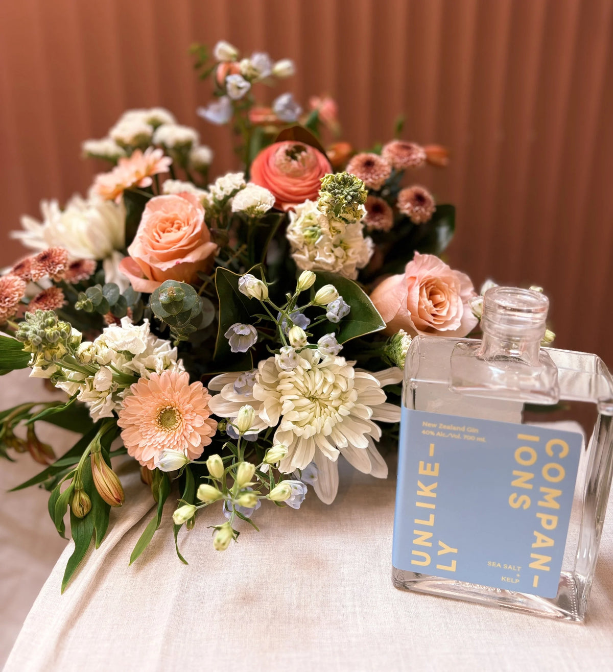 Unlikely Companions blue gin with a peach and white bouquet