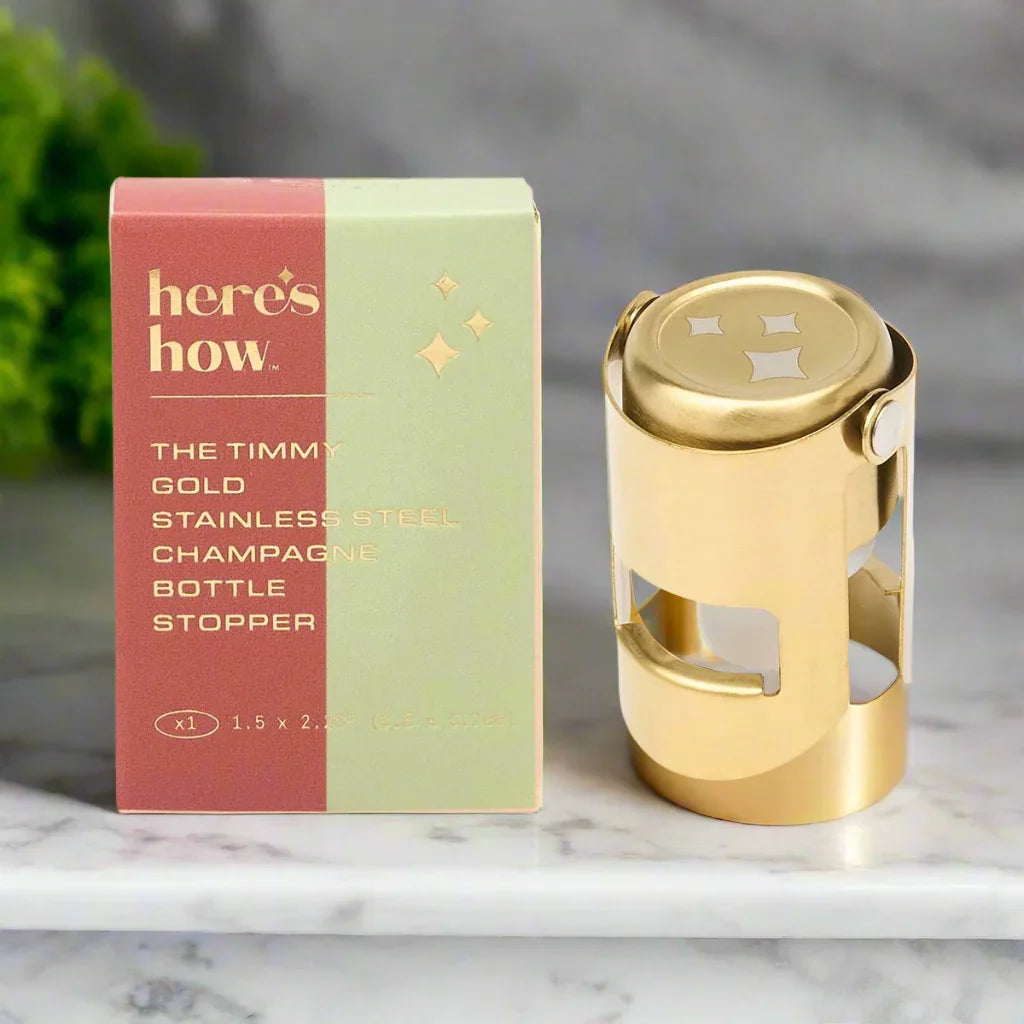 Timmy gold champagne stopper with its Here's How gift box
