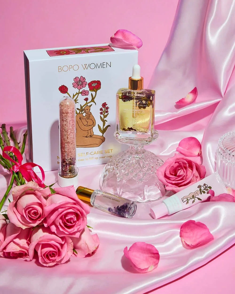 Mama's Self Care set with perfume, lip and skincare styled with pink roses