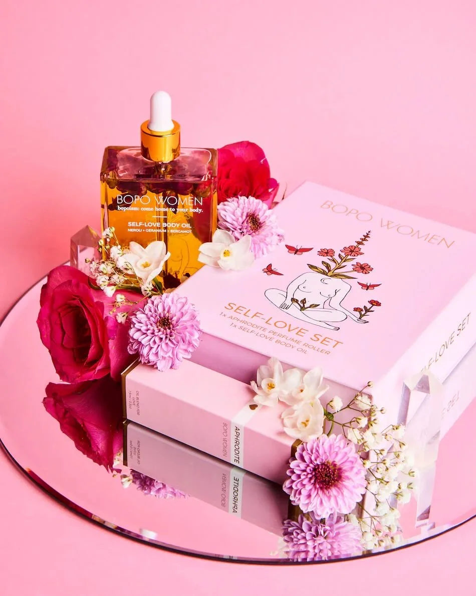 Self Love gift set with body oil and box styled with pink flowers