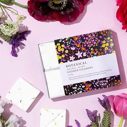 Ylang ylang & lavender shower steamers styled with purple flowers