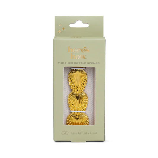 The Theo gold shell bottle opener in its gift box