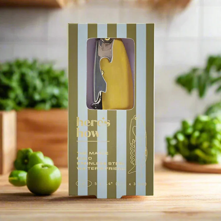 Maple fish bottle opener in a striped gift box styled with limes